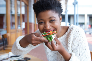 woman eating pizza work with a trusted oral surgeon santa rosa ca
